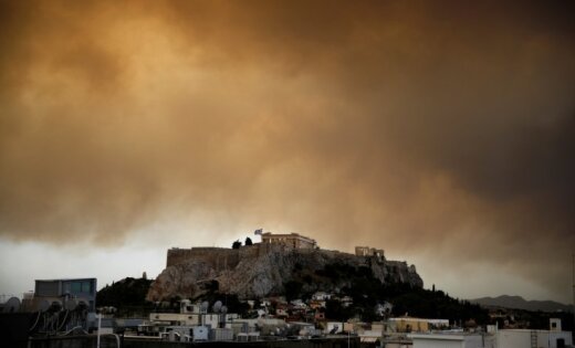   As a result of forest fires, people are forced to leave their homes on the outskirts of Athens 