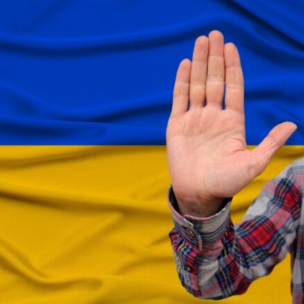 Предъявлены обвинения хулигану, напавшему на юношу с украинским флагом; в авто с нападавшим могла быть полицейская