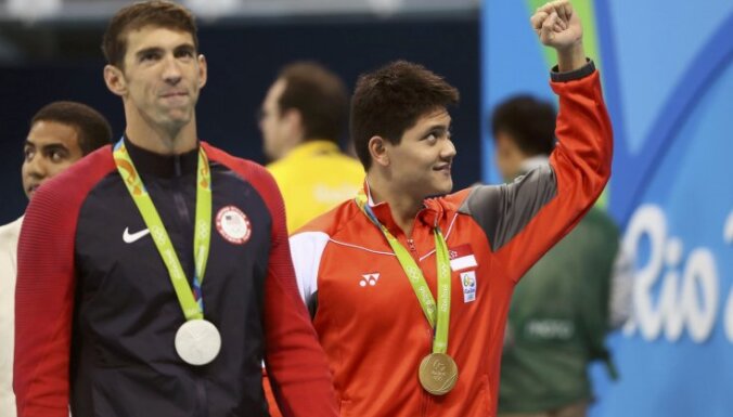 Joseph Schooling of Singapore celebrates win to Michael Phelps (USA)