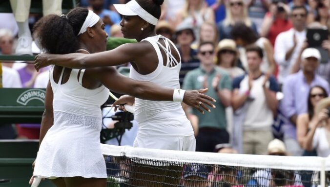 Serena Williams of the U.S.A. embraces Venus Williams