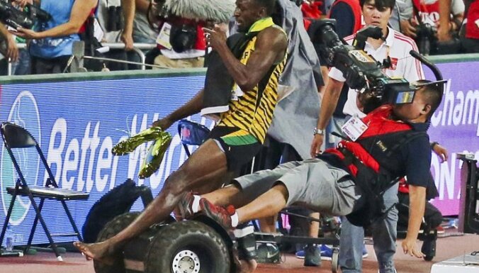 Usain Bolt of Jamaica is hit by a cameraman on a Segway